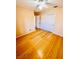 Bedroom with hardwood floors, ceiling fan, and a double-door closet at 1318 Pine Terrace Ct, North Las Vegas, NV 89031