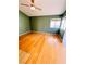 Bedroom with hardwood floors, ceiling fan, and multiple windows providing natural light at 1318 Pine Terrace Ct, North Las Vegas, NV 89031