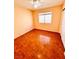 Bedroom with hardwood floors, window view, ceiling fan, and a sliding closet door at 1318 Pine Terrace Ct, North Las Vegas, NV 89031