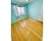 Bedroom with hardwood floors, natural light from the window and a white door at 1318 Pine Terrace Ct, North Las Vegas, NV 89031