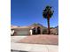 Single-story home with a two car garage and xeriscaping at 1318 Pine Terrace Ct, North Las Vegas, NV 89031