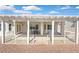 Covered back patio area with white beams and fencing, with table and chairs, and lovely landscaping at 1735 Black Fox Canyon Rd, Henderson, NV 89052
