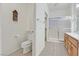 Well-lit bathroom featuring a toilet, shower with glass doors, and ample counter space at 1735 Black Fox Canyon Rd, Henderson, NV 89052