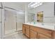 Bright bathroom featuring a double sink vanity and a spacious shower with sliding glass doors at 1735 Black Fox Canyon Rd, Henderson, NV 89052