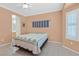 Comfortable bedroom with a ceiling fan and a bed. The bedroom has tile flooring at 1735 Black Fox Canyon Rd, Henderson, NV 89052