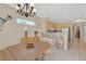Bright dining area with a chandelier, breakfast bar, and ample natural light from the nearby window at 1735 Black Fox Canyon Rd, Henderson, NV 89052