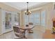 Sunny dining area featuring tile floors, a chandelier and access to the patio at 1735 Black Fox Canyon Rd, Henderson, NV 89052