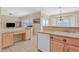 Well-lit kitchen featuring functional built-in desk space, a sink, and modern appliances at 1735 Black Fox Canyon Rd, Henderson, NV 89052