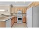 Well-equipped kitchen with sleek appliances, light wood cabinetry, and modern tile flooring at 1735 Black Fox Canyon Rd, Henderson, NV 89052