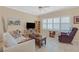 Cozy living room with neutral walls, tile flooring and plenty of natural light at 1735 Black Fox Canyon Rd, Henderson, NV 89052