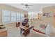 Bright living room with neutral decor, tile floors and a large window at 1735 Black Fox Canyon Rd, Henderson, NV 89052