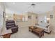 Open-concept living area with tile flooring, neutral walls and a view of the kitchen at 1735 Black Fox Canyon Rd, Henderson, NV 89052