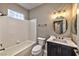 Bathroom with updated vanity, light fixture, and shower-tub combo at 2050 W Warm Springs Rd # 312, Henderson, NV 89014