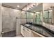 Updated bathroom featuring a walk-in shower and a modern vanity with black countertop at 2050 W Warm Springs Rd # 312, Henderson, NV 89014