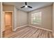 Bright bedroom with a ceiling fan, new wood-style flooring, and a large window at 2050 W Warm Springs Rd # 312, Henderson, NV 89014