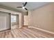 Bedroom with ceiling fan, wood-style flooring, and mirrored closet doors at 2050 W Warm Springs Rd # 312, Henderson, NV 89014