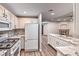 Modern kitchen featuring white cabinets, stainless steel appliances, and granite countertops at 2050 W Warm Springs Rd # 312, Henderson, NV 89014