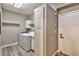 Laundry room with washer, dryer, storage cabinets, and wood-style flooring at 2050 W Warm Springs Rd # 312, Henderson, NV 89014