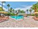 Community pool with mature palm trees, sun loungers, and shade at 2050 W Warm Springs Rd # 312, Henderson, NV 89014