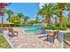 Beautiful pool area with lush landscaping, palm trees, and a connecting bridge to the main pool area at 2050 W Warm Springs Rd # 312, Henderson, NV 89014