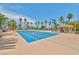 Two well-maintained blue tennis courts with surrounding landscaping, seating, and clear blue skies at 2050 W Warm Springs Rd # 312, Henderson, NV 89014