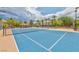 View of two tennis courts in the community with landscaping and palm trees at 2050 W Warm Springs Rd # 312, Henderson, NV 89014