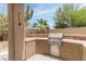 Outdoor BBQ area with stainless steel grill built into brick counter; perfect for outdoor dining and entertaining at 2056 Bay Thrush Way, North Las Vegas, NV 89084
