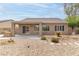 The backyard features a covered patio, desert landscaping, and a charming stone walkway at 2056 Bay Thrush Way, North Las Vegas, NV 89084