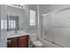 Bathroom offers cherry wood cabinet, shower, and shuttered window for natural light and privacy at 2056 Bay Thrush Way, North Las Vegas, NV 89084