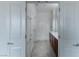 Bright bathroom featuring a walk-in shower, tile flooring, and vanity with a brown cabinet base at 2056 Bay Thrush Way, North Las Vegas, NV 89084