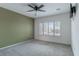 Light-filled bedroom with neutral carpet, ceiling fan, and plantation shutters at 2056 Bay Thrush Way, North Las Vegas, NV 89084