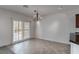 Bright dining area with tiled floors, shuttered windows, chandelier, and sliding glass doors at 2056 Bay Thrush Way, North Las Vegas, NV 89084