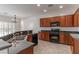 Well-equipped kitchen with dark cabinets, granite countertops, and modern appliances at 2056 Bay Thrush Way, North Las Vegas, NV 89084