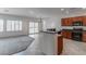 Open-concept kitchen featuring dark wood cabinets, granite countertops, and modern appliances at 2056 Bay Thrush Way, North Las Vegas, NV 89084