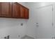 Functional laundry room featuring cabinets and tile flooring at 2056 Bay Thrush Way, North Las Vegas, NV 89084