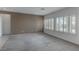 Spacious living room with neutral carpet, multiple windows with plantation shutters, and fresh paint at 2056 Bay Thrush Way, North Las Vegas, NV 89084