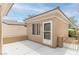 View of a private patio with a door and window, enclosed by a low wall for added privacy at 2056 Bay Thrush Way, North Las Vegas, NV 89084