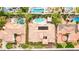 Overhead view of a terracotta-roofed home showcasing lush landscaping and neighborhood pools at 213 Villa Borghese St, Las Vegas, NV 89138
