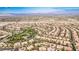 Expansive aerial view of a desert neighborhood with manicured landscaping and city views in the distance at 213 Villa Borghese St, Las Vegas, NV 89138