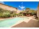 Backyard pool, spa, outdoor kitchen, and covered patio area surrounded by lush landscaping at 213 Villa Borghese St, Las Vegas, NV 89138