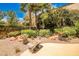 An inviting backyard featuring thoughtful desert landscaping and a mosaic tile bench at 213 Villa Borghese St, Las Vegas, NV 89138