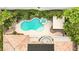 Aerial shot of a private kidney-shaped pool, spa, and covered patio in lush backyard at 213 Villa Borghese St, Las Vegas, NV 89138