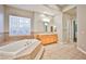 Bright bathroom with dual vanities, large tub, and glass block window for privacy at 213 Villa Borghese St, Las Vegas, NV 89138