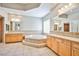 Bathroom featuring dual vanities and a large soaking tub with tiled surround at 213 Villa Borghese St, Las Vegas, NV 89138