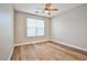 Bright bedroom featuring ceiling fan, wood-look flooring and window with blinds at 213 Villa Borghese St, Las Vegas, NV 89138