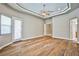 Expansive bedroom featuring hardwood floors, ceiling fan, and natural light from many windows and doors at 213 Villa Borghese St, Las Vegas, NV 89138