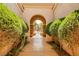 Charming arched entryway surrounded by lush greenery leading to a gated courtyard at 213 Villa Borghese St, Las Vegas, NV 89138
