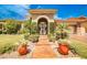 Inviting front entryway with potted plants and a landscaped walkway to the decorative gate at 213 Villa Borghese St, Las Vegas, NV 89138