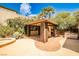 Outdoor kitchen and covered area next to a spa, surrounded by mature landscaping at 213 Villa Borghese St, Las Vegas, NV 89138