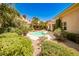 Inviting pool and hot tub area surrounded by lush, mature landscaping at 213 Villa Borghese St, Las Vegas, NV 89138